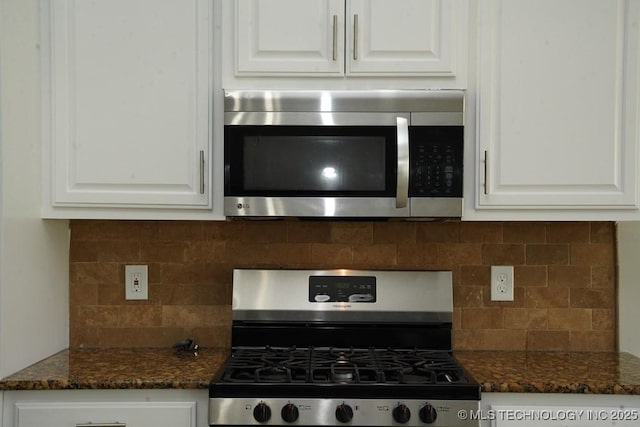 11906 S Nandina St, Jenks, OK 74037 - kitchen view of stainless steel appliances, white cabinets, decorative backsplash, and dark stone countertops