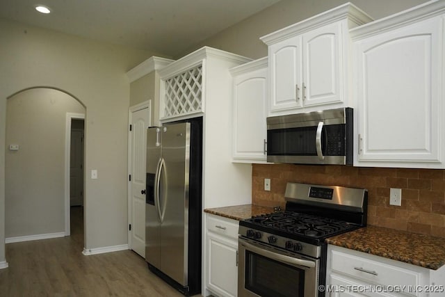 11906 S Nandina St, Jenks, OK 74037 - kitchen with appliances with stainless steel finishes, light wood-type flooring, tasteful backsplash, white cabinetry, and recessed lighting