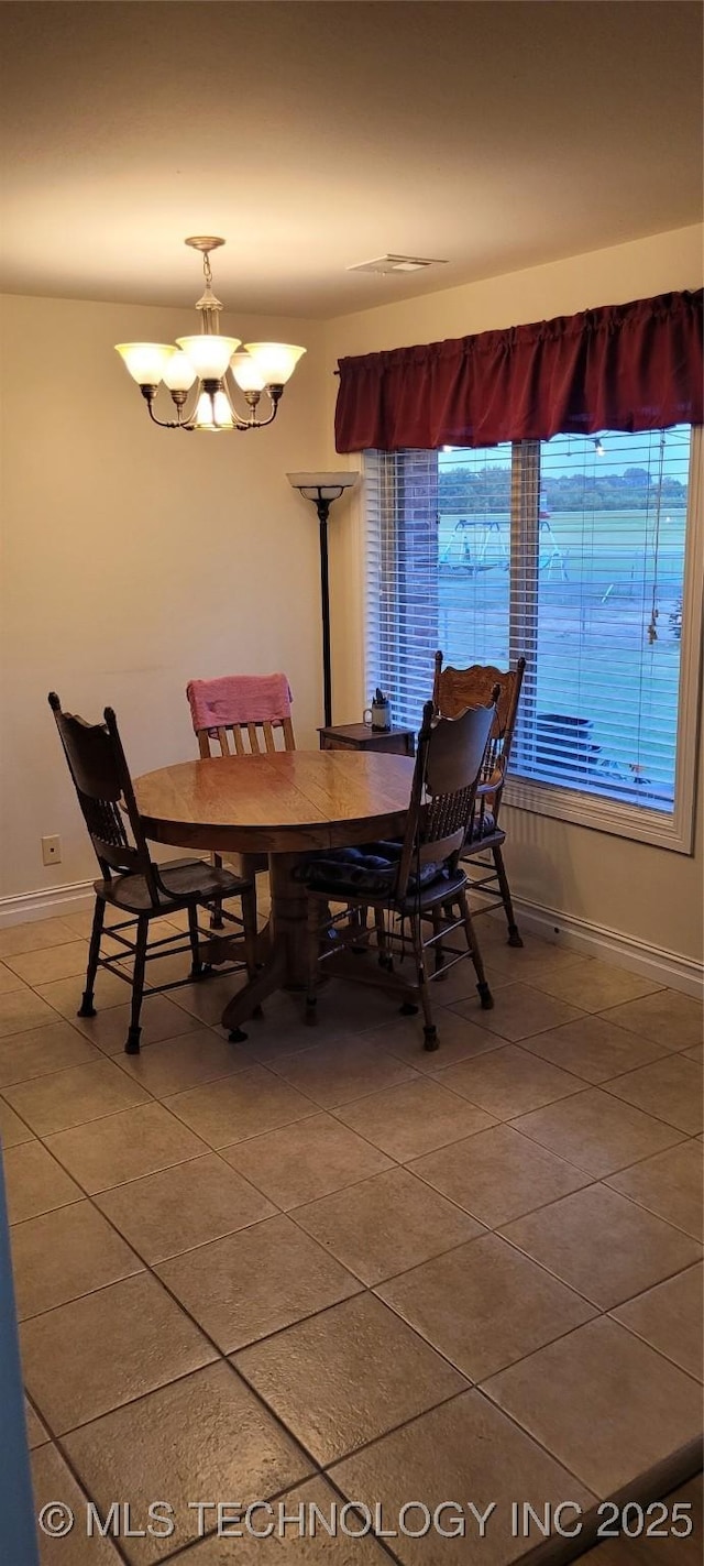 1704 Estates Dr, Grove, OK 74344 - dining space featuring light tile patterned flooring and a chandelier