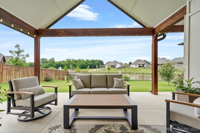 14305 S College Ave, Bixby, OK 74008 - fenced backyard with outdoor lounge area, a patio area, and a water view