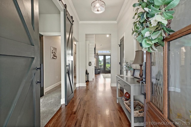 14305 S College Ave, Bixby, OK 74008 - entrance foyer with a barn door, dark wood-type flooring, and ornamental molding