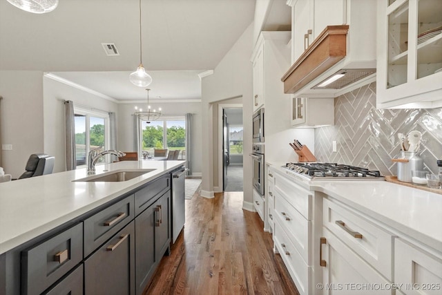 14305 S College Ave, Bixby, OK 74008 - kitchen featuring appliances with stainless steel finishes, white cabinets, light countertops, dark wood-style floors, and crown molding
