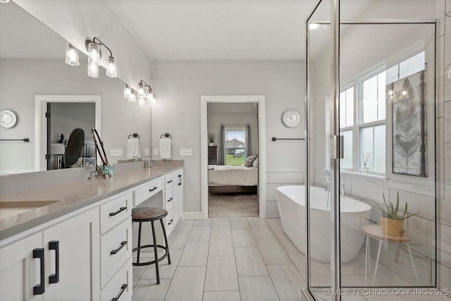14305 S College Ave, Bixby, OK 74008 - bathroom featuring connected bathroom, double vanity, a freestanding tub, and a stall shower