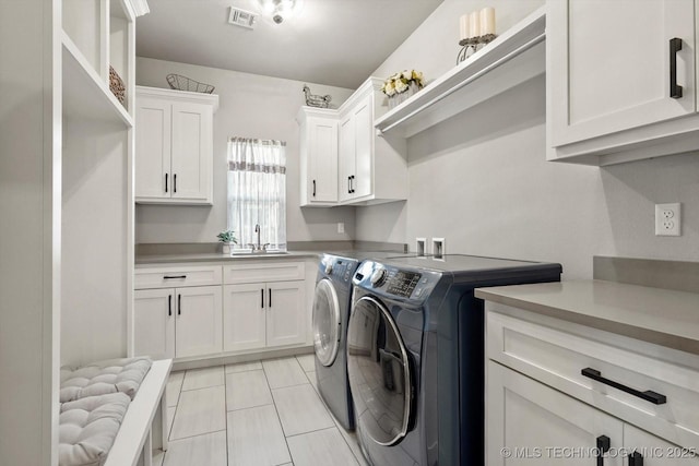 14305 S College Ave, Bixby, OK 74008 - laundry room with washing machine and clothes dryer, cabinet space, and light tile patterned flooring