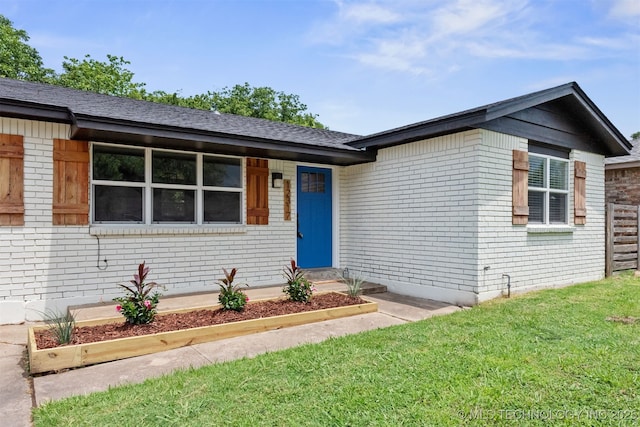 12317 E 18th St, Tulsa, OK 74128 - view of front of house featuring brick siding, a front lawn, and roof with shingles