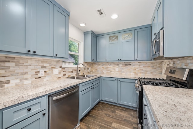 12317 E 18th St, Tulsa, OK 74128 - kitchen with stainless steel appliances, light countertops, dark wood-style floors, tasteful backsplash, and recessed lighting
