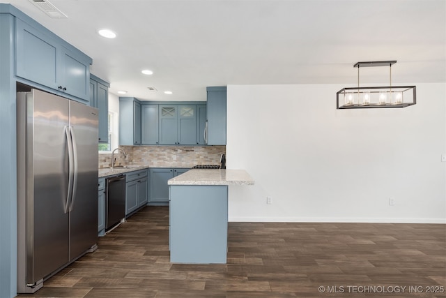 12317 E 18th St, Tulsa, OK 74128 - kitchen with appliances with stainless steel finishes, a peninsula, dark wood-style flooring, recessed lighting, and backsplash