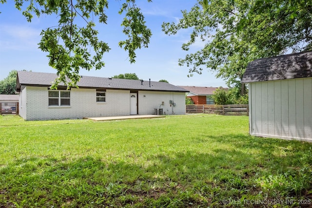 12317 E 18th St, Tulsa, OK 74128 - back of house with a patio area, a storage unit, and brick siding