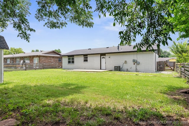 12317 E 18th St, Tulsa, OK 74128 - back of house featuring brick siding, a patio, and a fenced backyard
