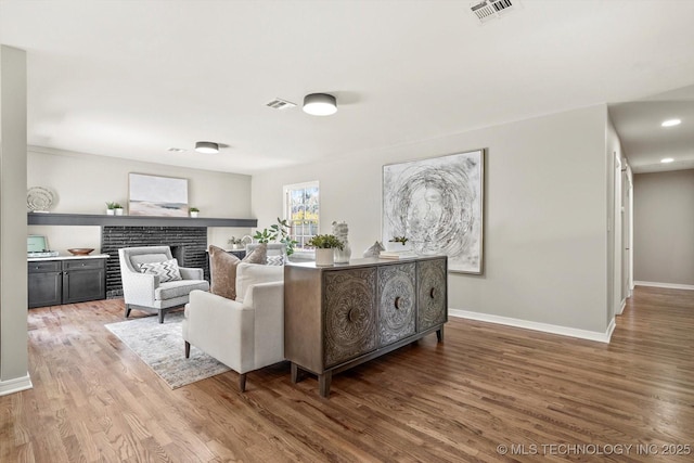 5861 S Hudson Pl, Tulsa, OK 74135 - living room featuring wood finished floors and a fireplace
