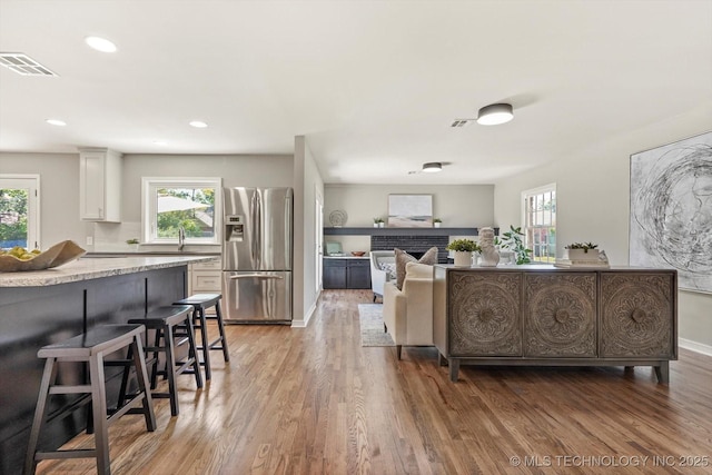 5861 S Hudson Pl, Tulsa, OK 74135 - living area with light wood-style floors, recessed lighting, and a brick fireplace