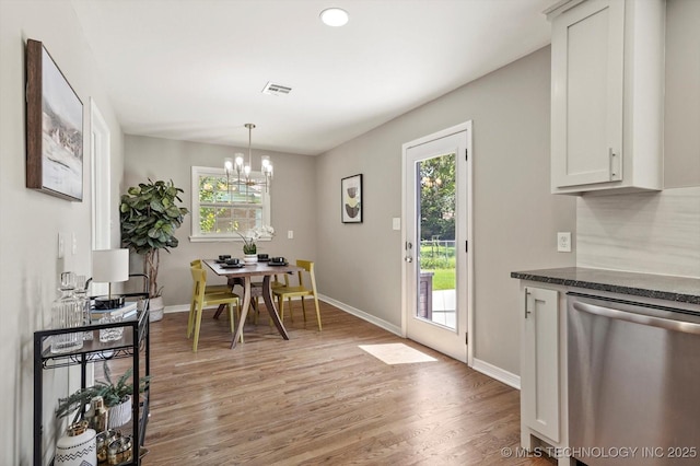 5861 S Hudson Pl, Tulsa, OK 74135 - dining space featuring plenty of natural light, light wood finished floors, and a chandelier