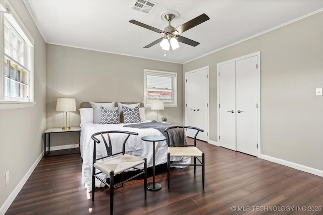 5861 S Hudson Pl, Tulsa, OK 74135 - bedroom with dark wood-style flooring, multiple closets, a ceiling fan, and crown molding