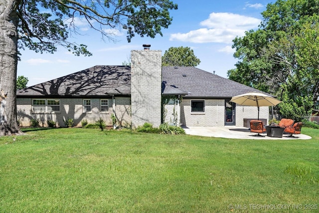 5861 S Hudson Pl, Tulsa, OK 74135 - back of property featuring a chimney, a patio area, roof with shingles, brick siding, and an outdoor fire pit