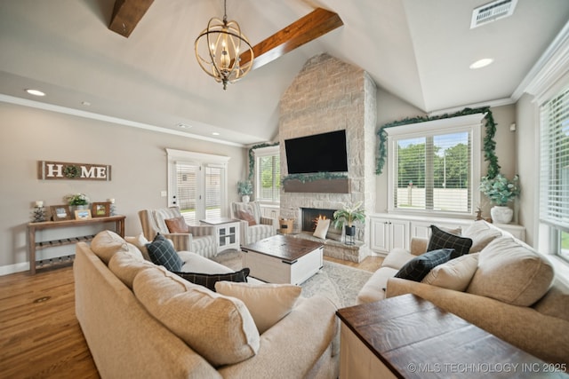 11802 S New Haven Ave, Tulsa, OK 74137 - living room featuring plenty of natural light, a chandelier, vaulted ceiling, wood finished floors, and a fireplace