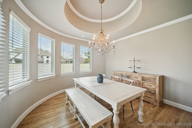 11802 S New Haven Ave, Tulsa, OK 74137 - dining room with light wood-type flooring, a raised ceiling, crown molding, and a chandelier