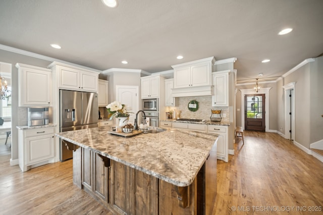 11802 S New Haven Ave, Tulsa, OK 74137 - kitchen featuring appliances with stainless steel finishes, ornamental molding, backsplash, recessed lighting, and an island with sink
