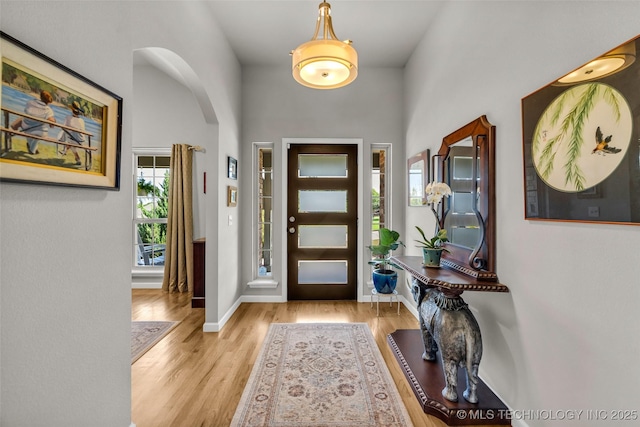 3331 Bunker St, Claremore, OK 74019 - foyer with wood finished floors, a towering ceiling, and arched walkways