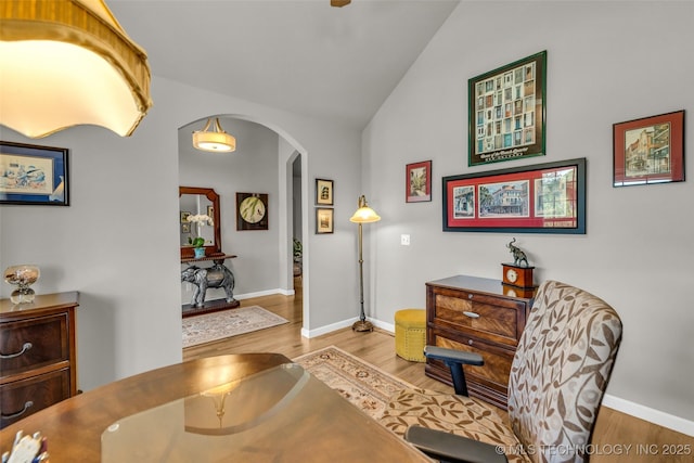 3331 Bunker St, Claremore, OK 74019 - living area featuring arched walkways, lofted ceiling, and wood finished floors