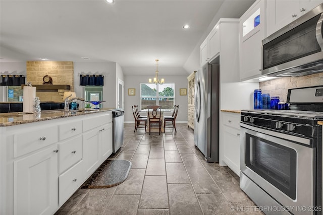 3331 Bunker St, Claremore, OK 74019 - kitchen featuring stainless steel appliances, a chandelier, decorative backsplash, white cabinetry, and recessed lighting