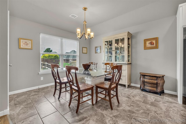 3331 Bunker St, Claremore, OK 74019 - dining space featuring a chandelier and light stone finish floors
