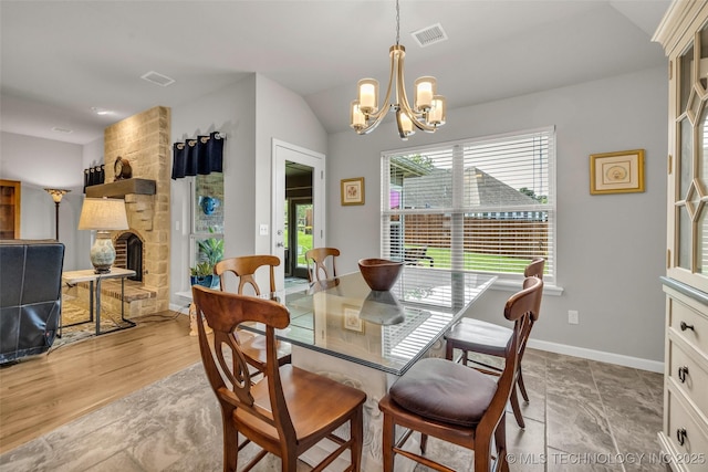 3331 Bunker St, Claremore, OK 74019 - dining space with a chandelier, a fireplace, and lofted ceiling