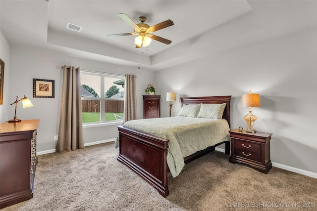 3331 Bunker St, Claremore, OK 74019 - bedroom with a tray ceiling, carpet flooring, and a ceiling fan