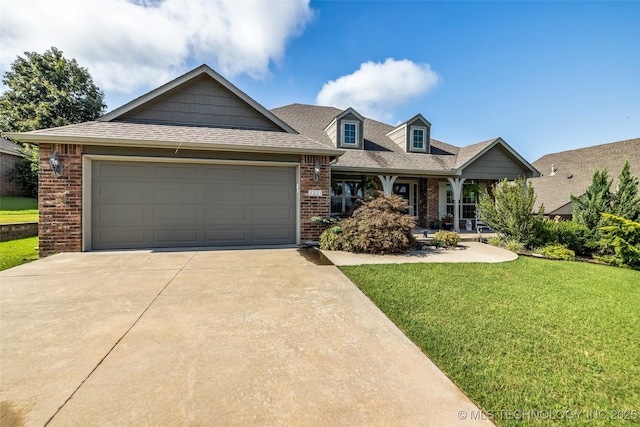 3331 Bunker St, Claremore, OK 74019 - view of front of property with driveway, brick siding, a front lawn, a garage, and covered porch