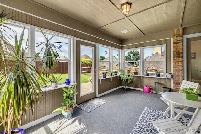 3331 Bunker St, Claremore, OK 74019 - unfurnished sunroom featuring carpet flooring and wood walls