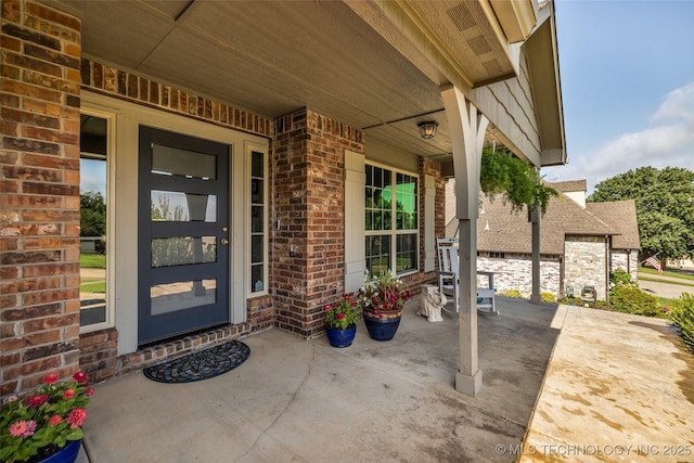 3331 Bunker St, Claremore, OK 74019 - doorway to property with brick siding and covered porch