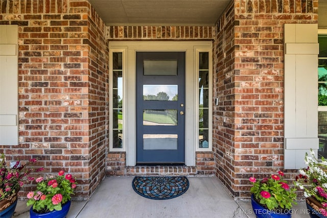 3331 Bunker St, Claremore, OK 74019 - view of exterior entry with brick siding and a porch