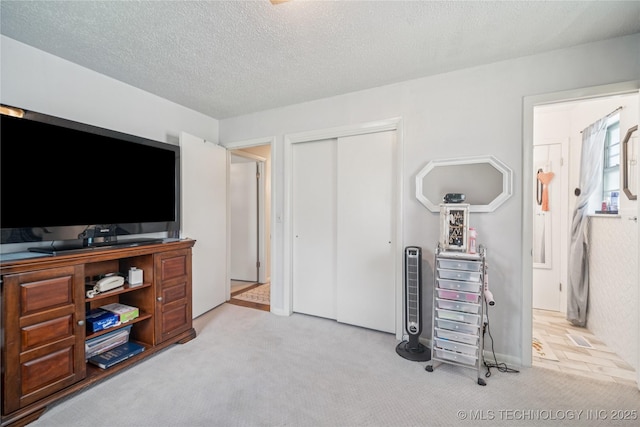 4647 S 30th W Ave, Tulsa, OK 74107 - carpeted bedroom with a closet and a textured ceiling