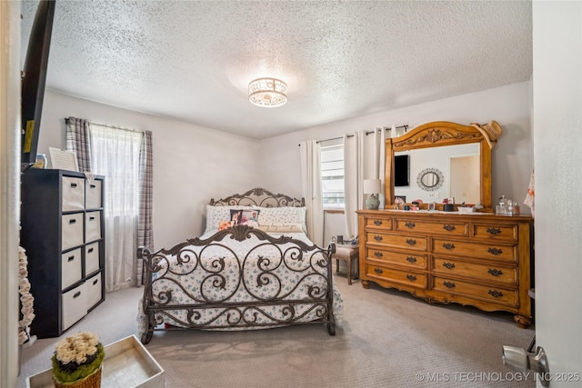 4647 S 30th W Ave, Tulsa, OK 74107 - bedroom with carpet flooring, multiple windows, and a textured ceiling