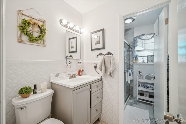 4647 S 30th W Ave, Tulsa, OK 74107 - full bath with vanity, tile walls, a stall shower, and wainscoting