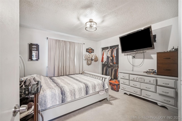 4647 S 30th W Ave, Tulsa, OK 74107 - carpeted bedroom featuring a closet and a textured ceiling