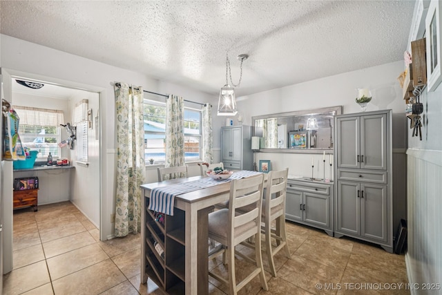 4647 S 30th W Ave, Tulsa, OK 74107 - dining area with a textured ceiling and light tile patterned floors
