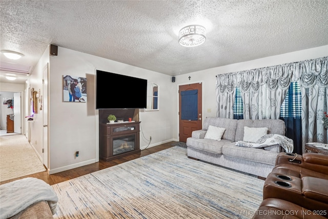4647 S 30th W Ave, Tulsa, OK 74107 - living room featuring a textured ceiling, wood finished floors, and a glass covered fireplace