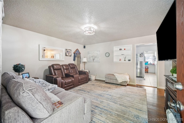 4647 S 30th W Ave, Tulsa, OK 74107 - living room featuring wood finished floors and a textured ceiling