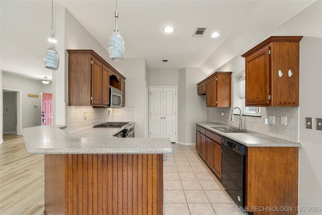 9005 N 154th E Ct, Owasso, OK 74055 - kitchen with appliances with stainless steel finishes, light countertops, a peninsula, decorative backsplash, and recessed lighting