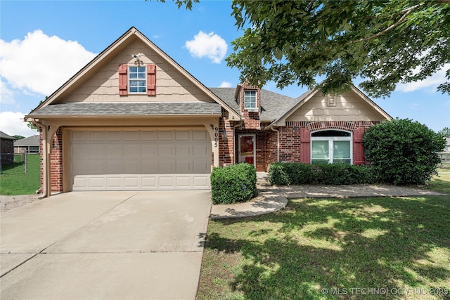 9005 N 154th E Ct, Owasso, OK 74055 - traditional-style house with brick siding, concrete driveway, a front yard, and a shingled roof