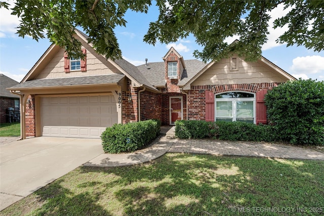 9005 N 154th E Ct, Owasso, OK 74055 - traditional home featuring brick siding, driveway, a shingled roof, and an attached garage