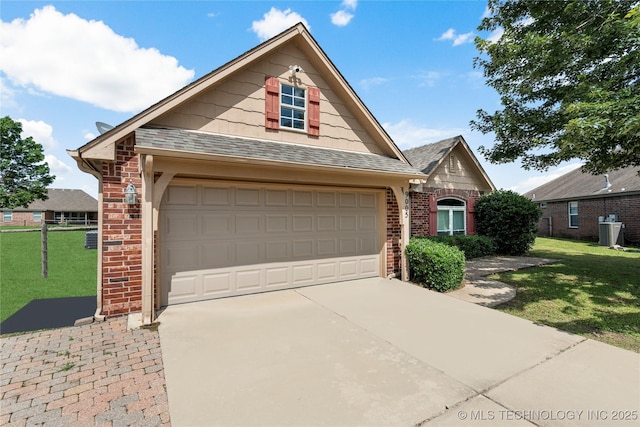 9005 N 154th E Ct, Owasso, OK 74055 - traditional-style house with brick siding, a front lawn, a garage, and driveway