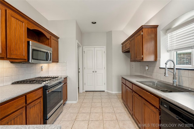 9005 N 154th E Ct, Owasso, OK 74055 - kitchen featuring appliances with stainless steel finishes, backsplash, light countertops, and brown cabinetry