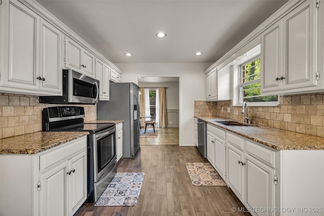 4350 E 74th Pl, Tulsa, OK 74136 - kitchen featuring appliances with stainless steel finishes, white cabinetry, healthy amount of natural light, and recessed lighting