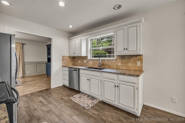 4350 E 74th Pl, Tulsa, OK 74136 - kitchen with appliances with stainless steel finishes, dark wood finished floors, white cabinets, recessed lighting, and wainscoting