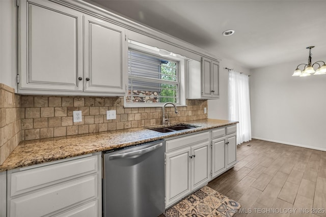 4350 E 74th Pl, Tulsa, OK 74136 - kitchen featuring stainless steel dishwasher, a chandelier, tasteful backsplash, wood finished floors, and light stone countertops