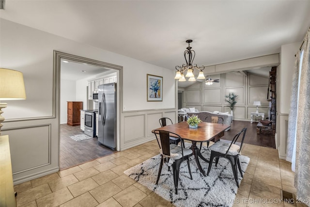 4350 E 74th Pl, Tulsa, OK 74136 - dining room featuring a decorative wall, a chandelier, and light tile patterned floors
