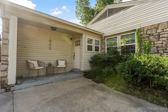 1640 E 41st St, Tulsa, OK 74105 - doorway to property featuring stone siding and a patio area