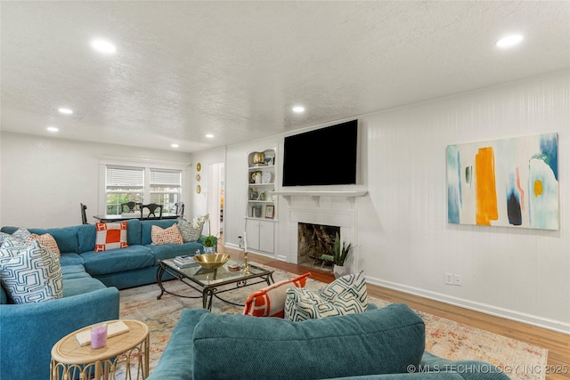 1640 E 41st St, Tulsa, OK 74105 - living area featuring a textured ceiling, recessed lighting, wood finished floors, and a fireplace