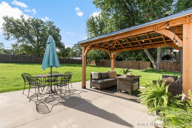 1640 E 41st St, Tulsa, OK 74105 - fenced backyard featuring a gazebo, a patio, outdoor dining area, and an outdoor hangout area